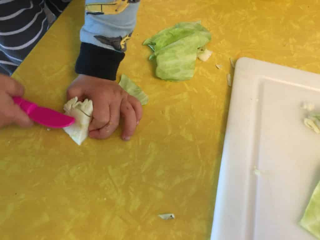 little fingers pretending to cut cabbage